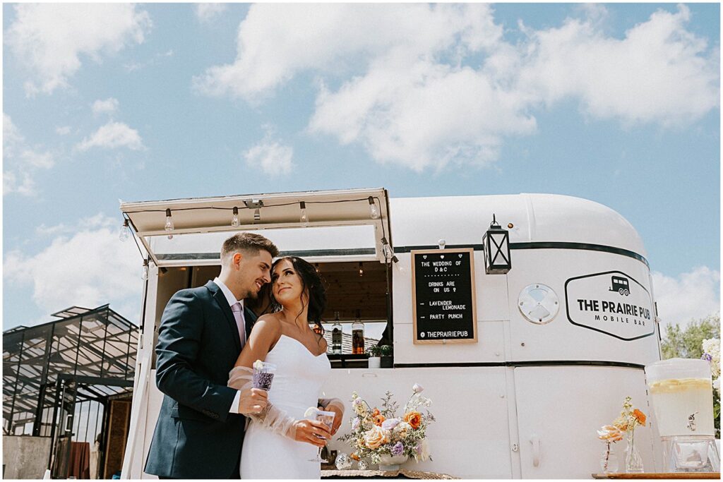 wedding couple portraits with drinks in front of mobile bar