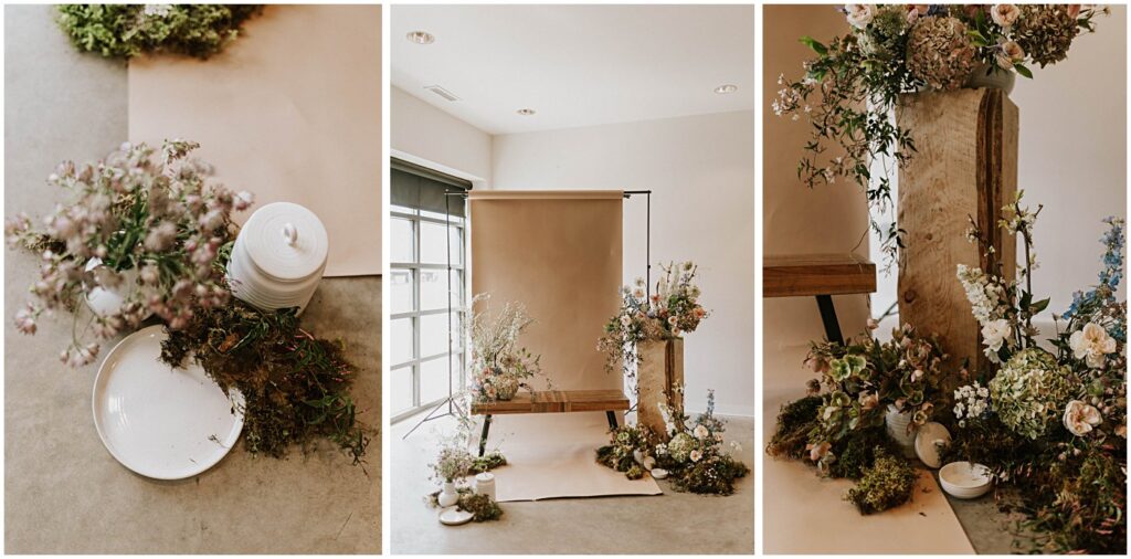 muted florals on a bench with a neutral backdrop, soft blush tones with earthy greens, wedding florist arranging flowers