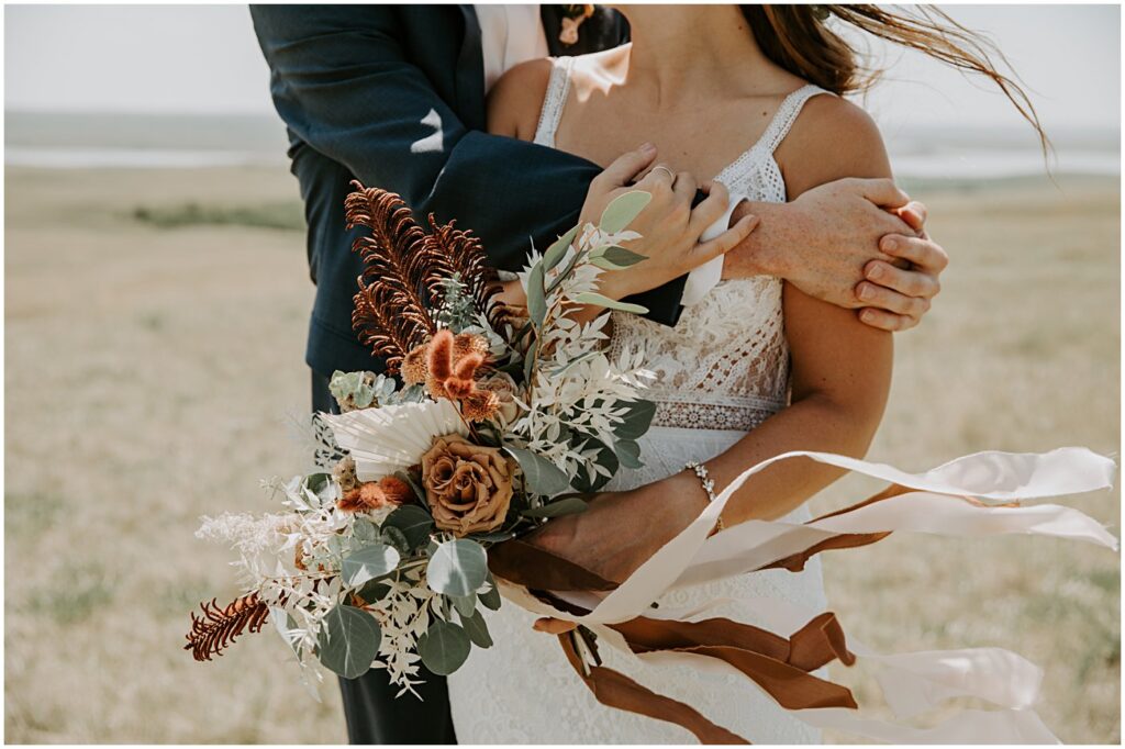 wedding couple portrait holding wedding florals