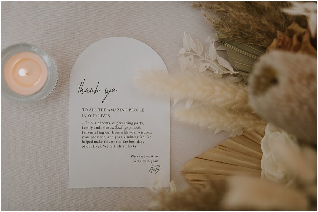 wedding reception table with a thank you note